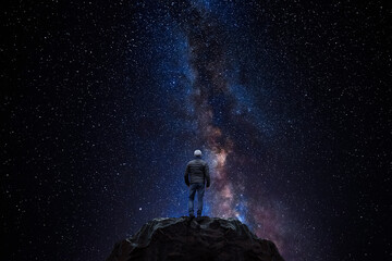 Wall Mural - man observes the universe from the top of a mountain
