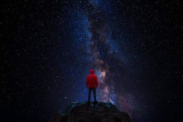 Wall Mural - man observes the universe from the top of a mountain