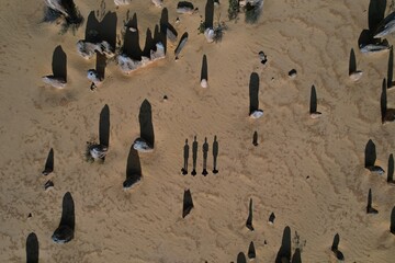 Aerial picture of four friends in the desert. Drone footage of static shadows in the middle of big stones at the pinnacles desert, Western Australia.