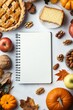 © ArtCookStudio - Autumn harvest display featuring apples, pumpkins, and a blank notebook for festive recipes