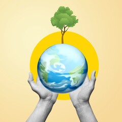 Hand holding earth with green tree