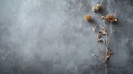 Poster -   A cluster of wilted blooms resting atop a gray backdrop adjacent to a pot filled with vibrant greenery