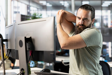 Poster - startup employee suffering arm pain from bad posture on office chair while doing research for projec