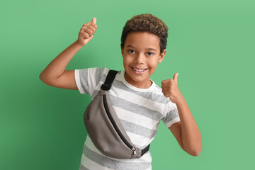 Canvas Print - Happy little African-American boy showing thumbs-up on green background