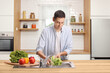© Ljupco Smokovski - Young man washing lettuce salad in a kitchen sink
