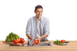 © Ljupco Smokovski - Young man washing tomato in a kitchen sink and smiling
