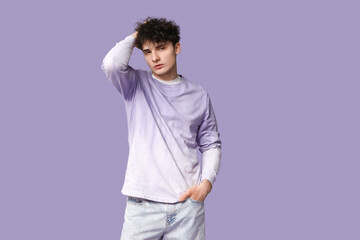 Wall Mural - Handsome young man in stylish clothes on purple background