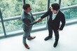 © InfiniteFlow - Businessman handshake with another businessman partner in modern workplace office. People corporate business deals concept. uds