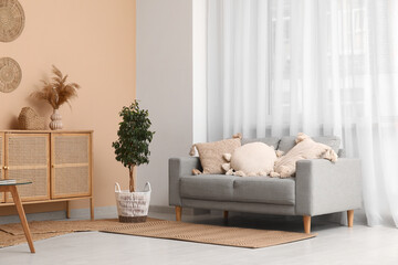 Wall Mural - Cozy sofa, houseplant and chest of drawers in living room