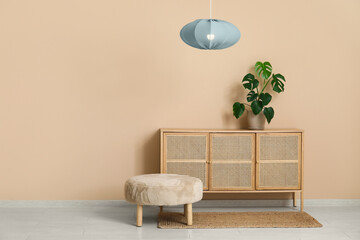 Canvas Print - Stylish living room with chest of drawers, houseplant, pouf and hanging lamp