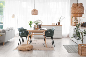 Poster - Pouf, chairs and table near window in interior of stylish dining room