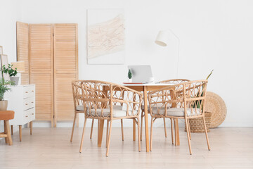 Poster - Table and wicker chairs near white wall in dining room