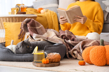 Poster - Glass cup of green tea with pumpkin and muffin in room on autumn day, closeup