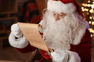 Canvas Print - Santa Claus reading letter at home on Christmas eve