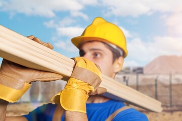 Construction worker in safety hat at building site,