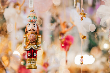 Sticker - Nutcracker doll.Christmas holiday symbol on a blurred backgroundChristmas toys and decorations.Winter festive beautiful background in gold tones