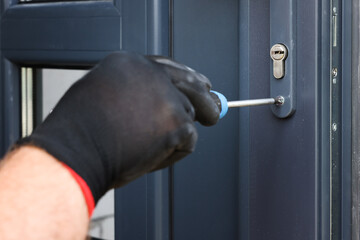 Canvas Print - Repairman installing new door with screwdriver indoors, closeup