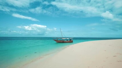 Sticker - A boat is securely docked on a sandy beach, with gentle waves lapping at the shore.
