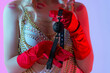© Granmedia - Beautiful blonde in a white sexy dress and red gloves holds a black gag for BDSM in her hand. Traces of kisses on the body and face. Blue pink background. BDSM is an outfit for adult sex games