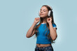 © Vagengeim - Girl with long hair enjoying music with eyes closed.