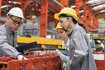 Asian male and female factory worker work training for conveyor at production line in industry factory. Group of factory worker working and control conveyor in manufacturing process in factory