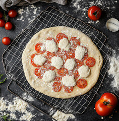 pizza with tomatoes and mozzarella, fresh pizza base dough thin, smooth and elastic, perfect form, pizza drying rack , top view