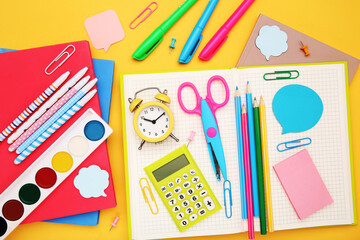 Wall Mural - School supplies on yellow background