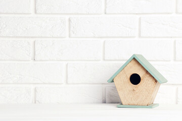 Wooden nesting box on brick wall background