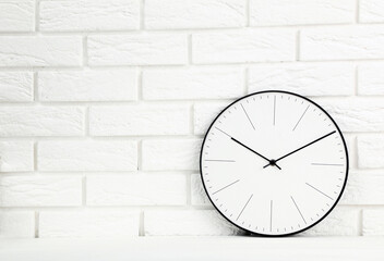 Wall Mural - Round clock on white brick wall background