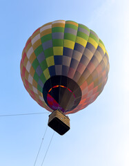 A colorful hot air balloon is floating in the sky