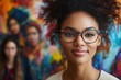 © Trusha - Woman with glasses is smiling at the camera. The image has a colorful background, which adds to the overall mood of the photo
