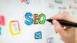 © Estefania - Writing 'SEO' on Whiteboard: A Hand Depicting Digital Strategy Planning