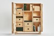 © Boinah - A wooden storage cabinet with various drawers and compartments for organization.