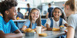 © Ekaterina Pokrovsky - Multiracial group of happy smiling children having lunch together in school canteen.