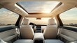 © Nuttaya Nampai - The interior of a modern car, viewed from the back seat, showcasing spacious seating, a panoramic sunroof, and a well-designed dashboard for a comfortable road trip vibe.