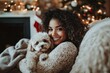 © Sanuji Weerasinghe - A young woman relaxing with her dog in a cozy Christmas setting, expressing warmth, care, and mental well-being. Perfect for promoting relaxation and festive moments of joy.