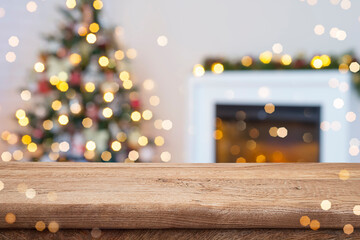 Wall Mural - holiday table background on blurred interior of christmas tree decoration and fireplace