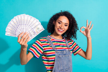 Canvas Print - Photo of positive girl hold money dollars show okay sign isolated blue color background