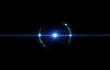© YiuCheung - A bright blue light shines in the center of a black background, surrounded by radiating lines and a faint blue circle.