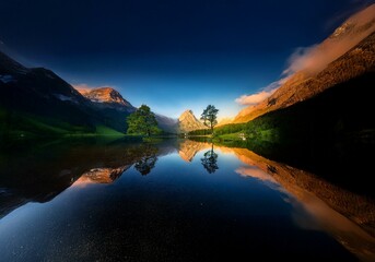 Poster - A serene mountain lake reflects the majestic peaks surrounding it, with a solitary tree standing tall in the center.