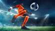 © master1305 - Athletic young African-American man in orange uniform, soccer player in motion on outdoor arena, dynamically playing under dramatic evening sky. Concept of sport, tournament, competition, game event