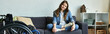 © Bliss - A young woman in a wheelchair sits on a couch in a modern apartment, showcasing a comfortable and accessible lifestyle