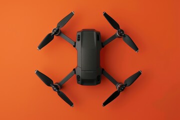 Drone positioned on a vibrant orange background showcasing its sleek design and propellers