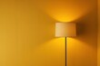 © Your Choice - A tall lamp casts a warm glow against a yellow wall in a cozy interior setting during the evening