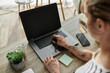© Bliss - The woman expresses her creativity while working at a modern desk setting.