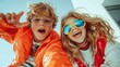 © svastix - Two happy children wearing colorful jackets and funky sunglasses smile widely, capturing a moment of pure joy and energy against a clear blue sky background.