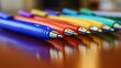 © Darunee - A row of pens in different colors lined up neatly on a desk, symbolizing choice and variety in writing tools