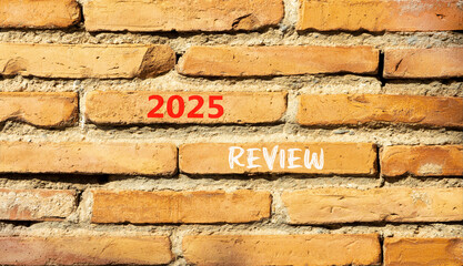 Planning 2025 review new year symbol. Concept words 2025 Review on beautiful brown brick wall. Beautiful brown brick wall background. Business 2025 review new year concept. Copy space.