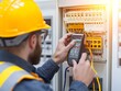 © Chanagun - Electrician working with circuit panel.