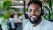 © Pinklife - A smiling customer service agent wearing a headset is ready to assist clients. With a friendly and professional demeanor, he represents dedication and communication.